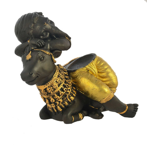Baby Ganesha Resting on Cow – Elegant Black & Gold Decorative Showpiece